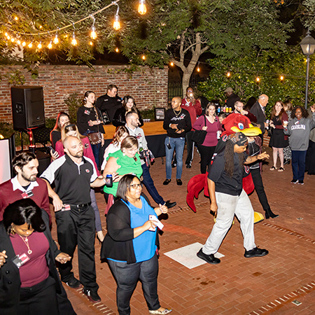 People gather on the dance floor at the HRSM Homecoming party.