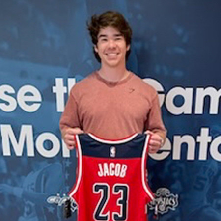 Dylan Jacob headshot holding Washington Capitals jersey