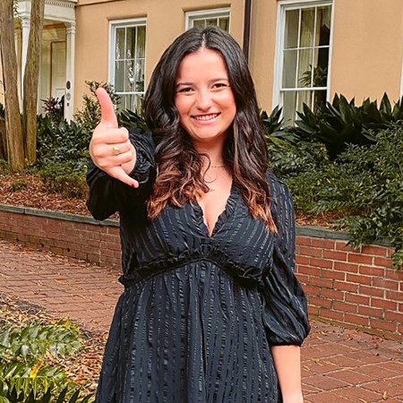 Meghan Keeler headshot giving Spurs Up sign