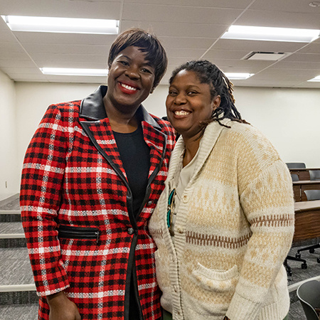 Two-time HRSM graduate Mamee Groves poes for a photo with a current student.