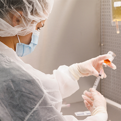 Pharmacy student working at a hood in the lab.