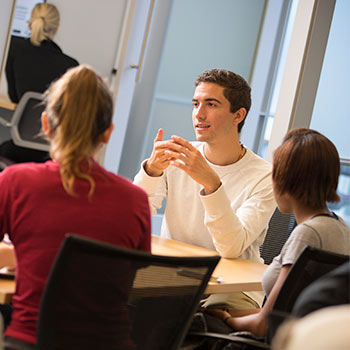 Students at a table studying together. 