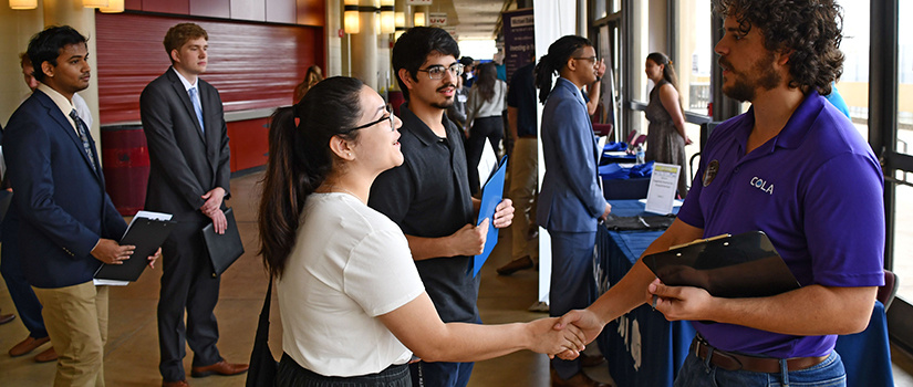 A recruiter speaks with a female student.