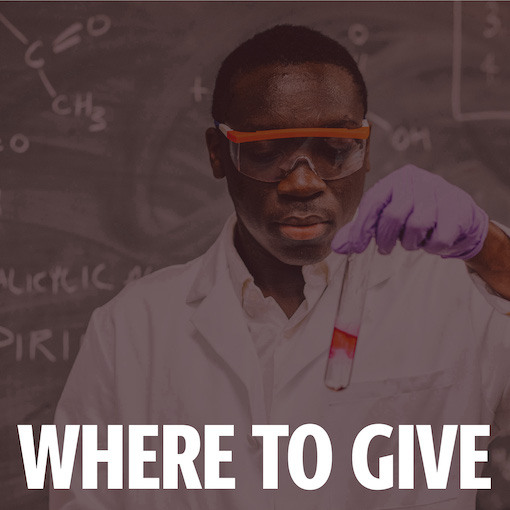 Kwame Kennedy, honors student in a white lab coat working with chemicals in a lab