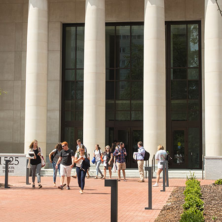 students exiting the main entrance of the school of law