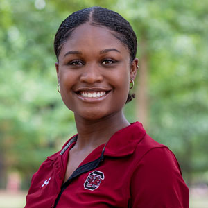 Hannah White smiles in garnet shirt