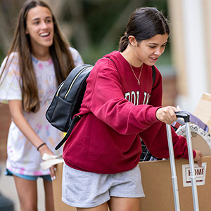 Two women moving into their housing in the fall of 2022