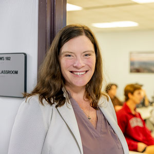 Katherine Ryker smiles in front of her office